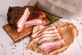 Smoked bacon sliced on a wooden cutting board. Close-up, selective focus.
