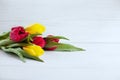 Wooden white background and yellow and red flowers. Conception h