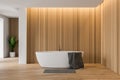 Wooden and white bathroom with white tub