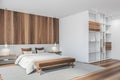 Wooden and white bedroom with bed with linens, carpet and big wardrobe Royalty Free Stock Photo