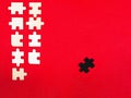 Wooden white and black puzzles on a red background outcast antisocial leader differ from others children educational toy