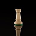 Wooden white chess rook isolated at dark background