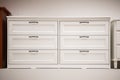 Wooden white dresser. Modern chest of drawers