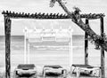 Wooden white gazebo by the beach with long chairs under it-HDR-BandW Royalty Free Stock Photo