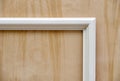 Wooden white molding on plywood background. Wood door manufacturing process. Furniture manufacture