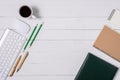 Wooden White office desk table with cup of coffee, Notebook, Pen Royalty Free Stock Photo