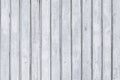 Wooden white painted palisade. Old shabby rustic fence with nails. Vintage gray wood texture, planks background. Royalty Free Stock Photo