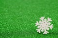 Wooden white snowflake, green shiny background, bokeh, color 2022, green bee