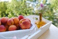 on wooden white tray plate with orange apricots, peach, bunch wild flowers on table in garden, beautiful summer still life, fruits Royalty Free Stock Photo