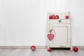 Wooden white wall for a background with red christmas balls. Royalty Free Stock Photo