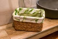 wooden wicker basket with towels on wooden shelf for bathroom Royalty Free Stock Photo