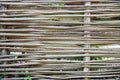 Wooden wicker fence made of sticks in the countryside Royalty Free Stock Photo