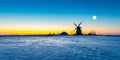 Wooden windmill on background winter sunrise. Dudutki village, Belarus Royalty Free Stock Photo