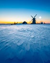 Wooden windmill on background winter sunrise. Dudutki village, Belarus Royalty Free Stock Photo