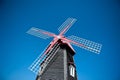 Wooden windmill with a blue sky background