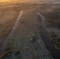 Wooden windmill in the countryside at dawn and fog in autumn, in the morning of the first frost.  top aerial view from drone Royalty Free Stock Photo
