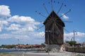 The wooden windmill on the isthmus Royalty Free Stock Photo