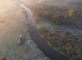 Wooden windmill by river in the countryside at dawn and fog in autumn, in the morning of the first frost. top aerial view from Royalty Free Stock Photo