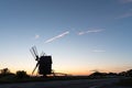 Wooden windmill silhouette by roadside