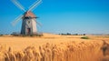 Wooden windmill standing amidst golden wheat fields under a clear blue sky