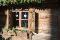 Wooden window of an alpine hut. Royalty Free Stock Photo