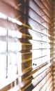 Wooden window blinds partially closed with bright light Royalty Free Stock Photo