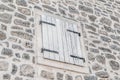 Wooden window closed with shutters on a stone wall in the Old Town of Budva Royalty Free Stock Photo