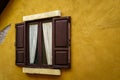 Wooden window with curtain on cracked yellow wall Royalty Free Stock Photo