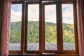 Wooden window with curtain of local homestay among tropical rainforest in vacation