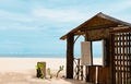 Wooden window frame by the sea in sunny day Summer,Beach hut on sandy beach with window open through ocean sea view,Seaside view Royalty Free Stock Photo