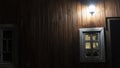 Wooden window with lighted wooden wall lanterns shining light in the dark. Space for text. Texture concept Royalty Free Stock Photo