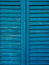 Wooden window shutters in blue. Antique homemade shutters on the