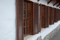 Wooden window with shutters in the long term