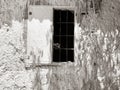Wooden window in stone building with metal bars Royalty Free Stock Photo