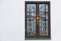 Wooden window with wrough gilt cross Royalty Free Stock Photo