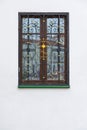 Wooden window with wrough iron cross Royalty Free Stock Photo