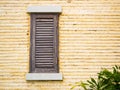 Wooden window on yellow brick wall Royalty Free Stock Photo