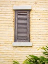 Wooden window on yellow brick wall Royalty Free Stock Photo