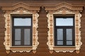 Wooden windows with carved platbands Royalty Free Stock Photo