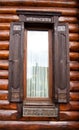 Wooden windows in a country log house made of wood, architecture