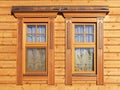 Wooden windows in paneled house wall