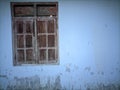 Wooden windows, peeling white paint walls