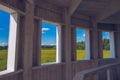 Wooden windows summer view. Window portal to the summer nature landscape. Meadow picturesque summer landscape with clouds on blue