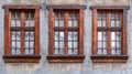 Wooden windows on a wall with a fire hydrant in front. Perfect for architectural or urban-themed designs Royalty Free Stock Photo