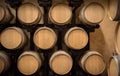 Wooden wine barrels in a row in winery cellar Royalty Free Stock Photo