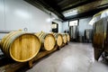 Wooden wine barrels stacked in modern winery cellar in Spain Royalty Free Stock Photo