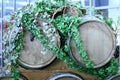 Wooden wine barrels for vineyards decorated with ivy leaves and bunches of grapes