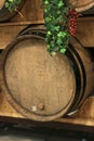 Wooden wine barrels for vineyards decorated with ivy leaves and bunches of grapes Royalty Free Stock Photo