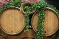 Wooden wine barrels for vineyards decorated with ivy leaves and bunches of grapes