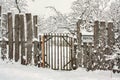 Wooden winter snowy fence with wicket and mailbox Royalty Free Stock Photo